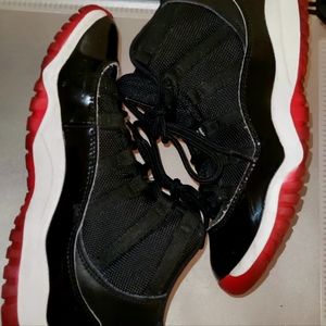 Kids black Jordan Retro 11s sneakers